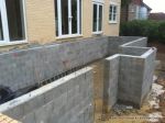 Deck and underfloor storage room built using Concrete block retaining wall with added rebar and wet concrete for strength 