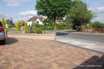 Curved Brick planter wall with crease tile and brick on edge to finish