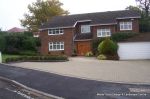 AFTER: New larger driveway constructed using pewter grey paving with contrasting colour band and feature curved double row of kerbs with Topiary hedge to retain level change.