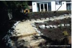 AFTER: Access to children's play area built via a steep slope with Irish rockery, decorative gravel and sleepers ready for planting  