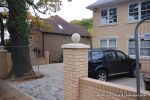 AFTER: Driveway was constructed with tumbled paver's in graphite grey, brick wall and pillars built using matching brick to property   