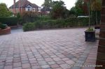 AFTER: Driveway installed with Tegula paving laid at 45 degree to property with in set lighting and feature wall merging into timber wall along front garden and road boundary