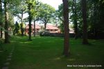 AFTER: Ground was cleared, cultivated and levelled over 100 tons of quality topsoil was then installed through limited access of 70cm this was then levelled and new lawns and grass/wild flower seeded meadows installed.