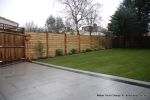 New Granite patio and path installed with contrasting dark colour band, New lawn, fencing and planting installed