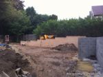 During: Site was cleared of all over grown shrub, new top soil installed and brick retainers constructed   