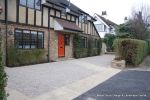 Sweeping sandstone path installed leading to front door, driveway perimeter edged with sandstone setts all hand pointed, Natural sandstone wall constructed with crease tile and 6mm Scottish beach gravel installed to 