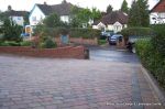 Driveway installed with Tegula paving laid at 45 degree to property with in set lighting and feature wall merging into timber wall along front garden and road boundary