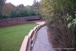 Stepped retaining Concrete block wall with added rebar and concrete for strength and facing brick to finish