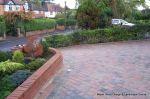 AFTER: Driveway installed with Tegula paving laid at 45 degree to property with in set lighting and feature wall merging into timber wall along front garden and road boundary