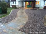 AFTER: Sweeping sandstone path installed leading to front door, driveway perimeter edged with sandstone setts all hand pointed, Natural sandstone wall constructed with crease tile and 6mm Scottish beach gravel installed to drive.