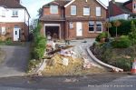 BEFORE: Driveway is excavated and hardcore based and construction is in progress 