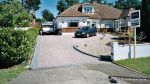 Sweeping curved driveway installed with Marshalls Driveline 50 in brindle and Charcoal Kerbs