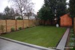 New Granite patio and path installed with contrasting dark colour band, New lawn, fencing and planting installed