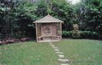 Fresh topsoil and new lawn installed with curved stepping stone path leading to tranquil arbour seating all overgrown shrubs and trees carefully cutback and new feature planting with lighting and irrigation installed