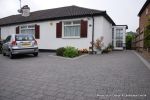 New driveway installed using granite paving with contrasting colour band and inset lights