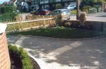 AFTER: Driveway constructed using Tegula paving with sweeping curved path to front door and feature band across drive mouth, new wall, lawn and planting installed.