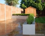 patio was constructed useing fossil sandstone in 4 sizes laid to a random pattern with a curved block planter wall painted in gun ship grey and planted with a topiary hedge.