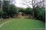 AFTER: Fresh topsoil and new lawn installed with curved stepping stone path leading to tranquil arbour seating all overgrown shrubs and trees carefully cutback and new feature planting with lighting and irrigation installed 