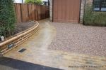 Sweeping sandstone path installed leading to front door, driveway perimeter edged with sandstone setts all hand pointed, Natural sandstone wall constructed with crease tile and 6mm Scottish beach gravel installed to 