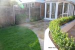 patio was constructed useing fossil sandstone in 4 sizes laid to a random pattern with a curved block planter wall painted in gun ship grey and planted with a topiary hedge.