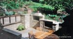 Sunken patio/dining area with natural Cotswald random stone retaining Walls with Integral BBQ and timber beams 