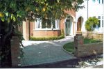 Driveway constructed using Tegula paving with sweeping curved path to front door and feature band across drive mouth, new wall, tier drop lawn and planting installed.