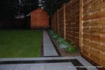 New Granite patio and path installed with contrasting dark colour band, New lawn, fencing and planting installed