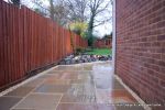 Patio installed with 4 size sawn sandstone paving edged with firestone rocks and alpine planting, steps built with sawn sandstone uprights and sawn sandstone bullnose treads