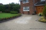 AFTER: New larger driveway constructed using pewter grey paving with contrasting colour band and feature curved double row of kerbs with Topiary hedge to retain level change.