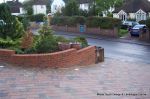 AFTER: Driveway installed with Tegula paving laid at 45 degree to property with in set lighting and feature wall merging into timber wall along front garden and road boundary