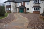 Sweeping sandstone path installed leading to front door, driveway perimeter edged with sandstone setts all hand pointed, Natural sandstone wall constructed with crease tile and 6mm Scottish beach gravel installed to drive