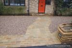 Sweeping sandstone path installed leading to front door, driveway perimeter edged with sandstone setts all hand pointed, Natural sandstone wall constructed with crease tile and 6mm Scottish beach gravel installed to drive