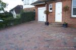 Driveway installed with Tegula paving laid at 45 degree to property with in set lighting and feature wall merging into timber wall along front garden and road boundary