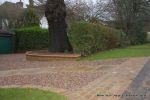 Sweeping sandstone path installed leading to front door, driveway perimeter edged with sandstone setts all hand pointed, Natural sandstone wall constructed with crease tile and 6mm Scottish beach gravel installed to 