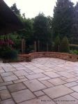 AFTER: Feature tumbled sandstone circle in cased with old stock brickwork with double bullnose on top