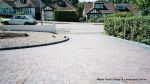 Sweeping curved driveway installed with Marshalls Driveline 50 in brindle and Charcoal Kerbs