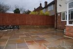 Patio installed with 4 size sawn sandstone paving edged with firestone rocks and alpine planting, steps built with sawn sandstone uprights and sawn sandstone bullnose treads