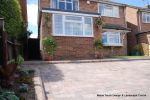 AFTER: Driveway installed with Tegula paving with added jumper block, kerbs installed to retain split levels and feature circle lawn and fencing installed. 