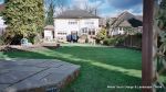 New sandstone patio installed with inset water feature with stepping stones across it, patio retaining wall constructed and new sweeping lawn edged with red brick leading to octagon sandstone patio 